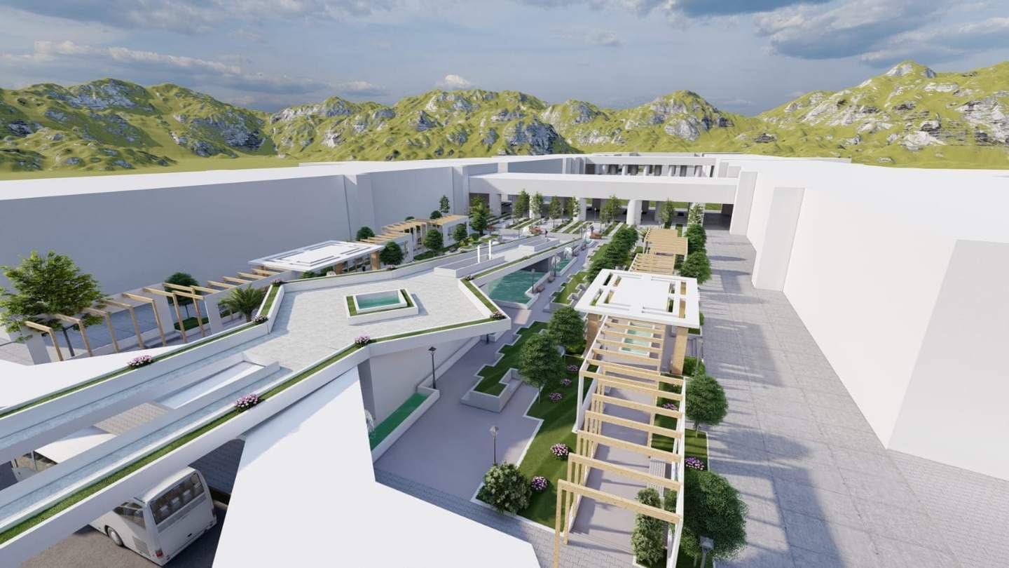 The spine crossing the bus drop-off, with its pools and planted parapets